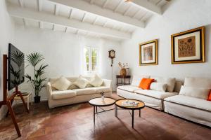 a living room with two couches and a table at Finca Biniparrell Vell by Escape Home in Sant Lluis