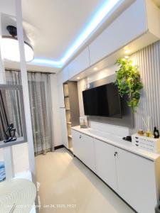 a living room with a flat screen tv on a wall at Miestee Humble abode 1101 in Lapu Lapu City