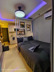 a bedroom with a bed with a laptop on it at Miestee Humble abode 1101 in Lapu Lapu City
