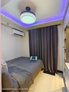 a bedroom with a bed with a laptop on it at Miestee Humble abode 1101 in Lapu Lapu City