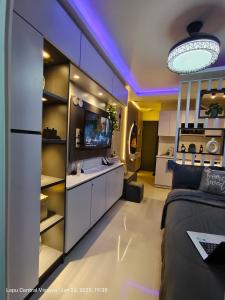 a living room with a couch and a kitchen at Miestee Humble abode 1101 in Lapu Lapu City