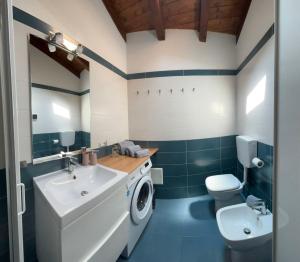 a bathroom with a washing machine and a sink at Vallicella House in Fanano +39 photos