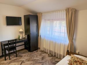 En eller flere senge i et værelse på HOTEL ARKA