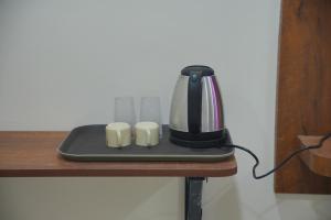 a coffee maker sitting on top of a table at Hotel Mount Royale in Hyderabad