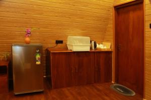 a room with a refrigerator next to a wooden wall at Villa Anaa in Habaraduwa Central