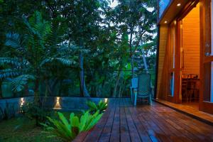 a wooden deck with a chair on a house at Villa Anaa in Habaraduwa Central