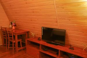 a living room with a tv and a table with a table at Villa Anaa in Habaraduwa Central +11 photos