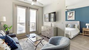 a living room with a bed and a couch and a table at Landing Apartments - The Quinn in Anna +39 photos