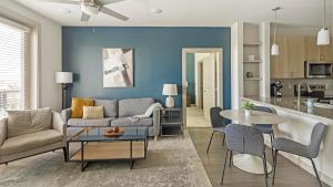 a living room with a couch and a table at Landing Apartments - The Quinn in Anna