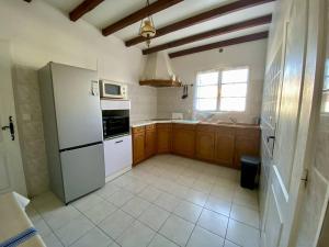 a kitchen with a white refrigerator and a window at Maison basque à Espelette, 3 chambres, 5+2 pers, animaux admis, internet - FR-1-495-2 in Espelette