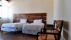 una camera da letto con due letti e una testiera in legno di Sorba Lodge Lalibela a Lalībela