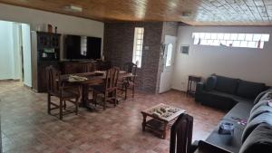 a living room with a couch and a table and chairs at Complejo Casablanca Plottier in Plottier