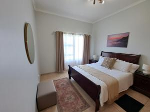 a bedroom with a large bed and a window at Das Moven Haus in Swakopmund