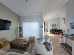 a living room with a white couch and a table at Das Moven Haus in Swakopmund