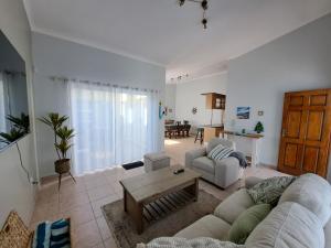 a living room with a couch and a table at Das Moven Haus in Swakopmund