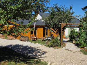 a house with a fence and a yard with trees at Koppány Pines Rewild Escapes - Hungarian Village Vendeghaz in Koppányszántó