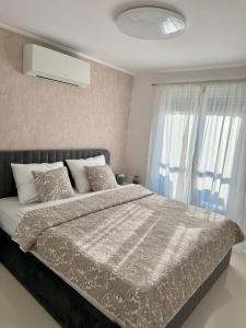 a bedroom with a large bed and a window at Apartmani Beril Lux in Rovinj