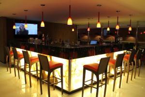 a bar with a bunch of chairs around it at Flat Radisson Hotel Belem in Belém