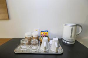 a tray with cups and a coffee maker on a table at Flat Radisson Hotel Belem in Belém