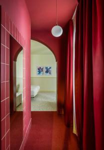 a room with red walls and a red hallway at BYPILLOW The Citadel in Madrid