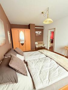 a bedroom with a large bed with two pillows at SeeNah in Niederdorla +5 photos