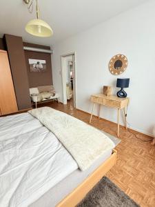 a bedroom with a large bed and a table at SeeNah in Niederdorla