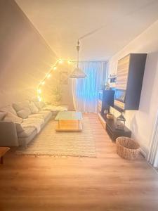 a living room with a couch and a table at SeeNah in Niederdorla