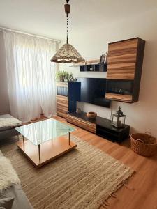 a living room with a glass table and a couch at SeeNah in Niederdorla