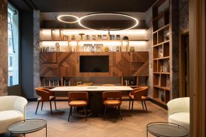 a dining room with a table and chairs and a tv at Palazzo 4 Fontane 12 in Rome
