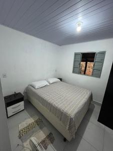 En eller flere senge i et værelse på Chácara Ouro de Mina