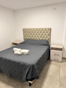 a bedroom with a bed with two towels on it at Vicente apart 2 - CON COCHERA in Villa María