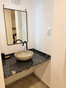 a bathroom with a sink and a mirror at Vicente apart 2 - CON COCHERA in Villa María +17 photos