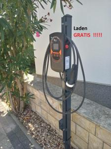 a parking meter with a hose attached to it at Apartment R A M L J A K - Apartman "Rafael" in Vodice