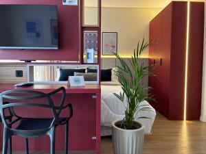 a bedroom with a bed and a desk and a chair at BetaSuites in Curitiba