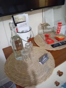 a bottle and glasses sitting on top of a table at Owls Roost in Stowmarket