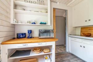a kitchen with white cabinets and a counter with food at KAL1031-Boda-Glasbruk-Storgatan-32 in Boda Glasbruk