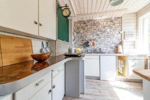a kitchen with white cabinets and a counter top at KAL1031-Boda-Glasbruk-Storgatan-32 in Boda Glasbruk