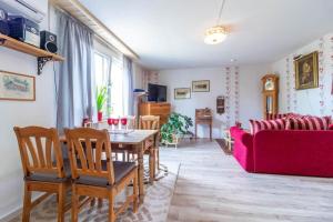 a living room with a table and a red couch at KAL1031-Boda-Glasbruk-Storgatan-32 in Boda Glasbruk