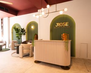 a lobby with a rose sign on a green door at Jrose Hotel in Jerusalem