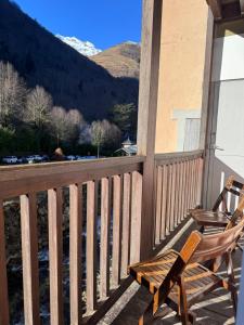een schommelstoel op een veranda met uitzicht op de bergen bij Résidence Le Georgina in Cauterets +6 foto's