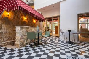 a restaurant with a checkered floor at Jrose Hotel in Jerusalem