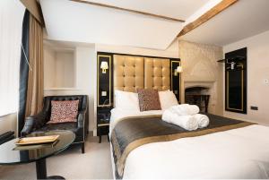 een hotelkamer met twee bedden en een stoel bij Museum Residence Oxford in Oxford