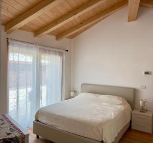 a bedroom with a large bed and a window at Chalet Ski Home - Madesimo in Madesimo +12 photos