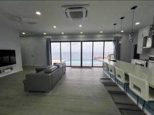 a living room with a large kitchen with a view of the ocean at Samaya Villa in Mesopotamia +30 photos