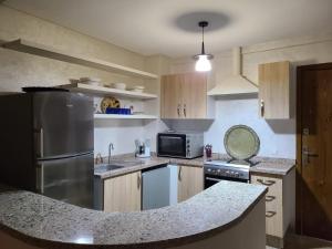 a kitchen with a stainless steel refrigerator and a counter top at santa barbara in Mansouria
