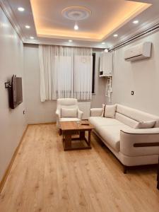 a living room with a couch and a table at Bediroğlu apart in Arnavutköy