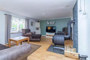 a living room with a couch and a fireplace at KAL911-Hjorted-Sandekulla in Gissebo