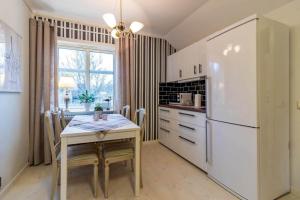 een keuken met een tafel en een witte koelkast bij JON832-Mansarp-Bondstorp-Bjoerksaeter-1 in Bondstorp
