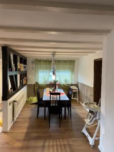 a dining room with a table and chairs at Ferienwohnung I&I in Halsenbach