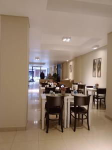 a dining room with tables and chairs in a restaurant at Viasui Hotel in Buenos Aires